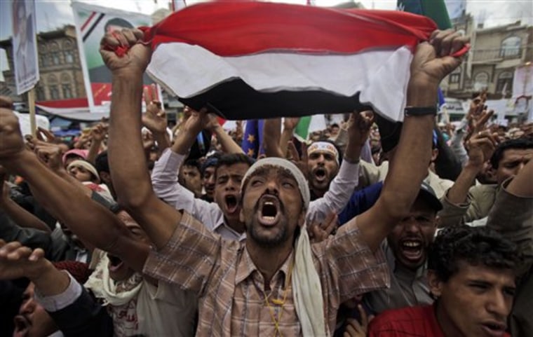 Anti-government protesters react during a demonstration demanding the resignation of Yemeni President Ali Abdullah Saleh, in Sanaa, Yemen, on Sunday. Government forces shot bullets and tear gas at demonstrators in Yemen's capital and another city on Saturday as longtime President Ali Abdullah Saleh resisted a diplomatic push for the resignation that hundreds of thousands of his own people were demanding in the streets.